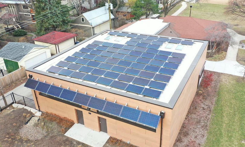 Carroll Center in Oak Park, Illinois, featuring a solar panel-covered roof, recognized as a net-zero energy building, promoting sustainable energy solutions.